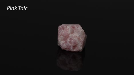 pink talc mineral specimen rotating on black background