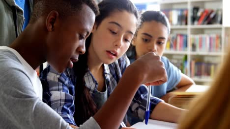 Schoolkids-using-digital-tablet-in-library-4k