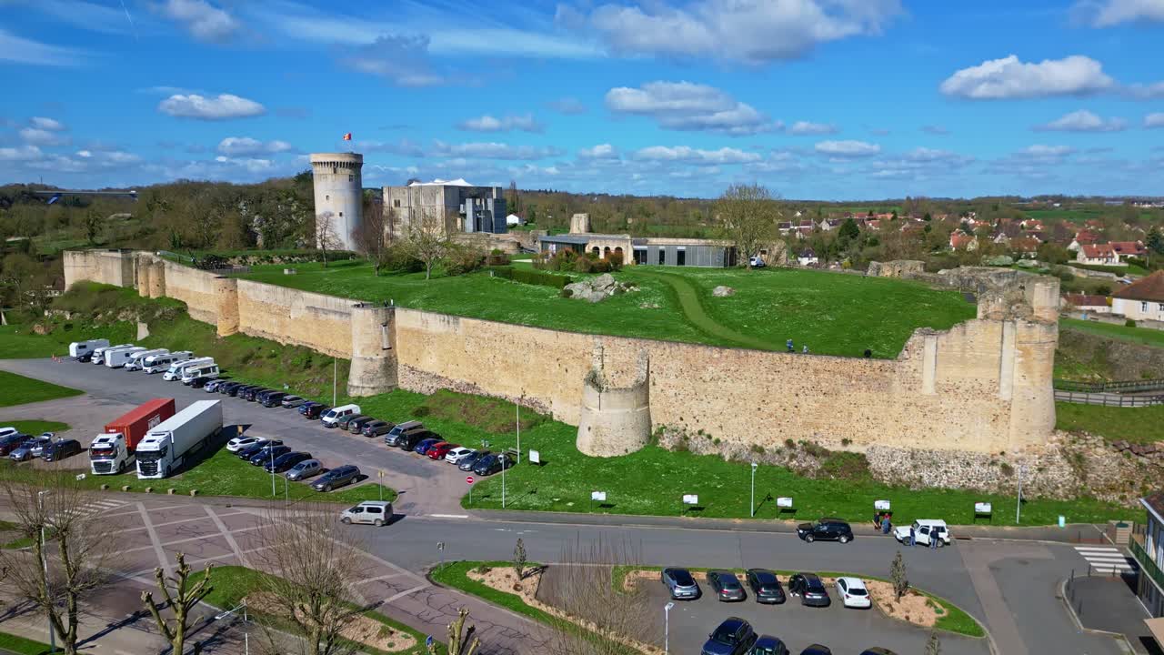 Imposing stone walls and entrance to historic Château de Falaise, William the Conqueror's castle, Normandy, France. Aerial drone ascending