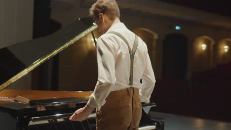 pianist walking on stage and playing piano with emotion
