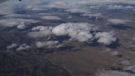 aerial view of america above the clouds out of plane window 4k