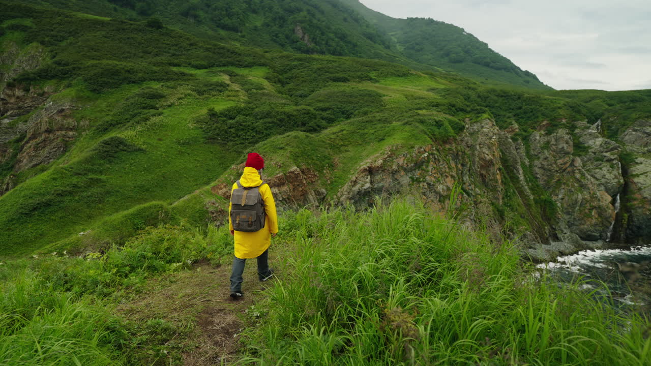 Woman Hiking Along a Rocky Coastline