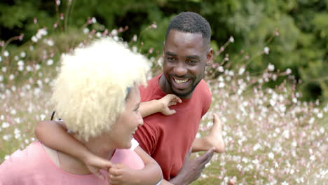 a young biracial woman with family enjoys a playful moment outdoors at home