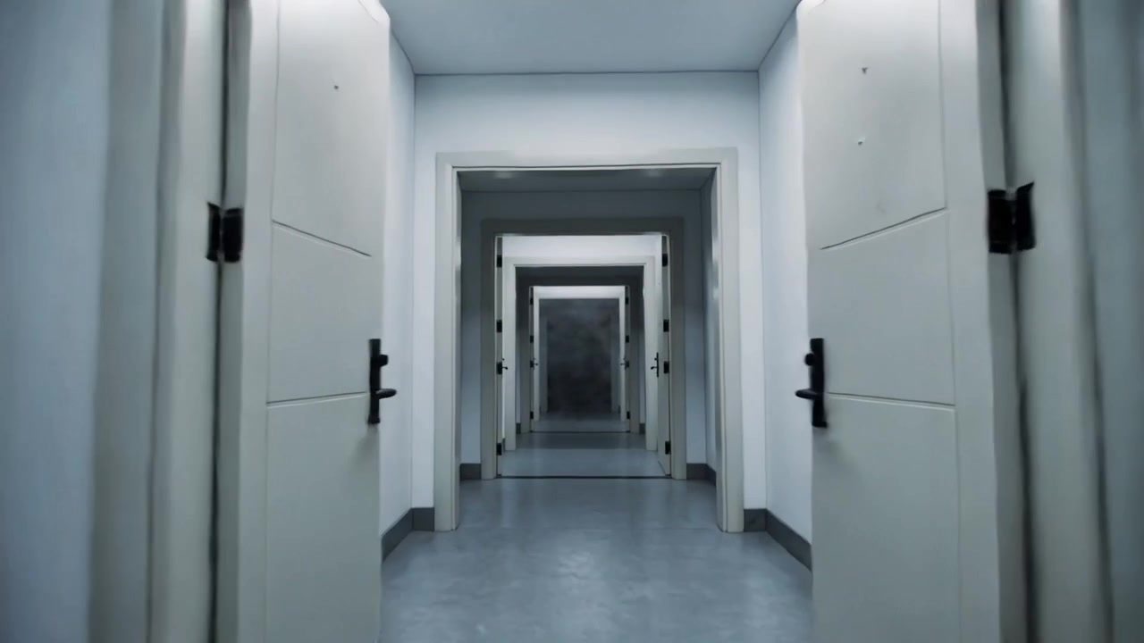 Tracking camera moving forward through atrium revealing nested doors and black metal spiral stairs