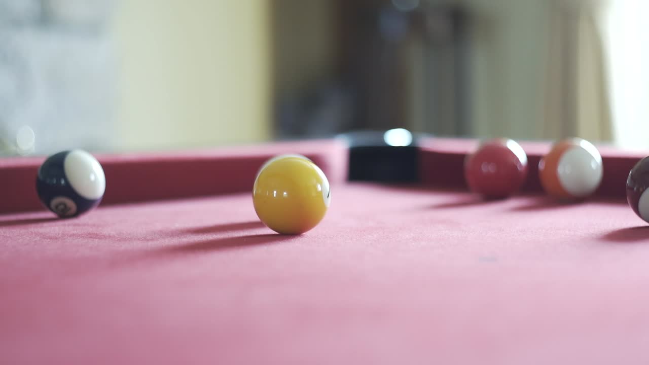 Snooker ball rolling around snooker table
