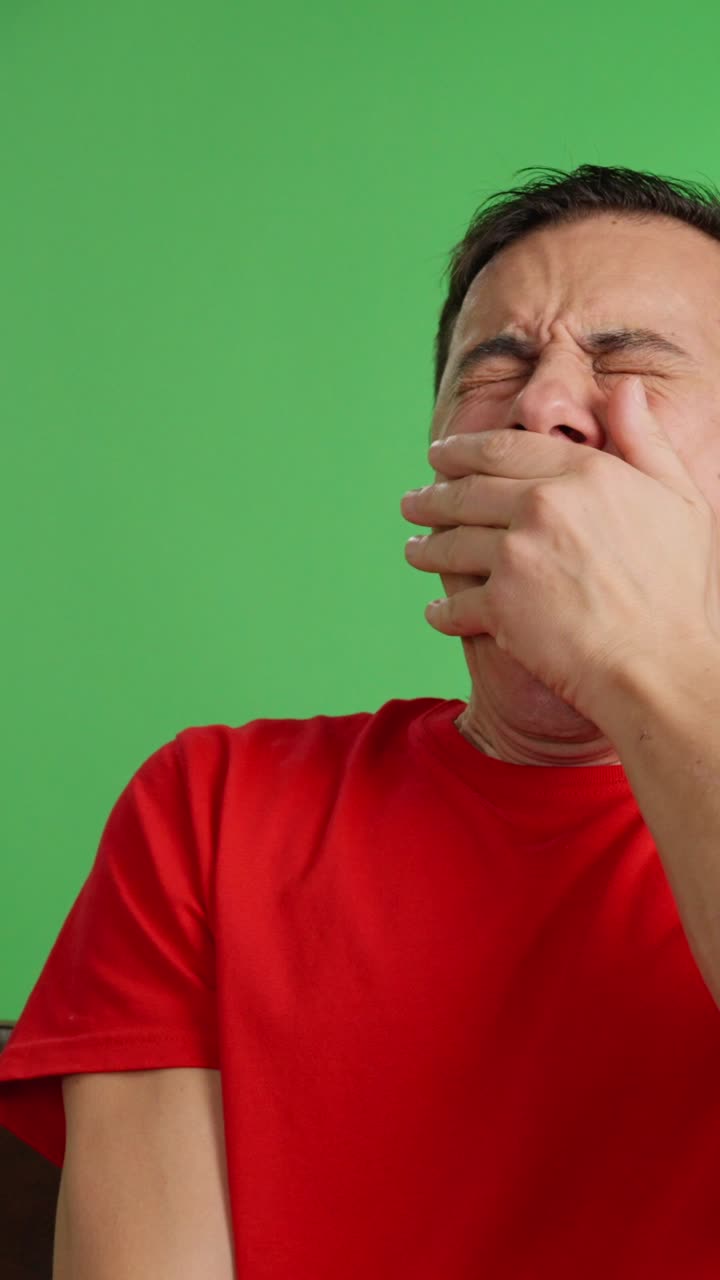 Tired man falls asleep watching a movie on TV