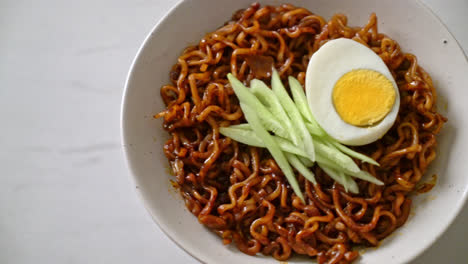 korean instant noodle with black bean sauce topped cucumber and boiled egg - korean food style