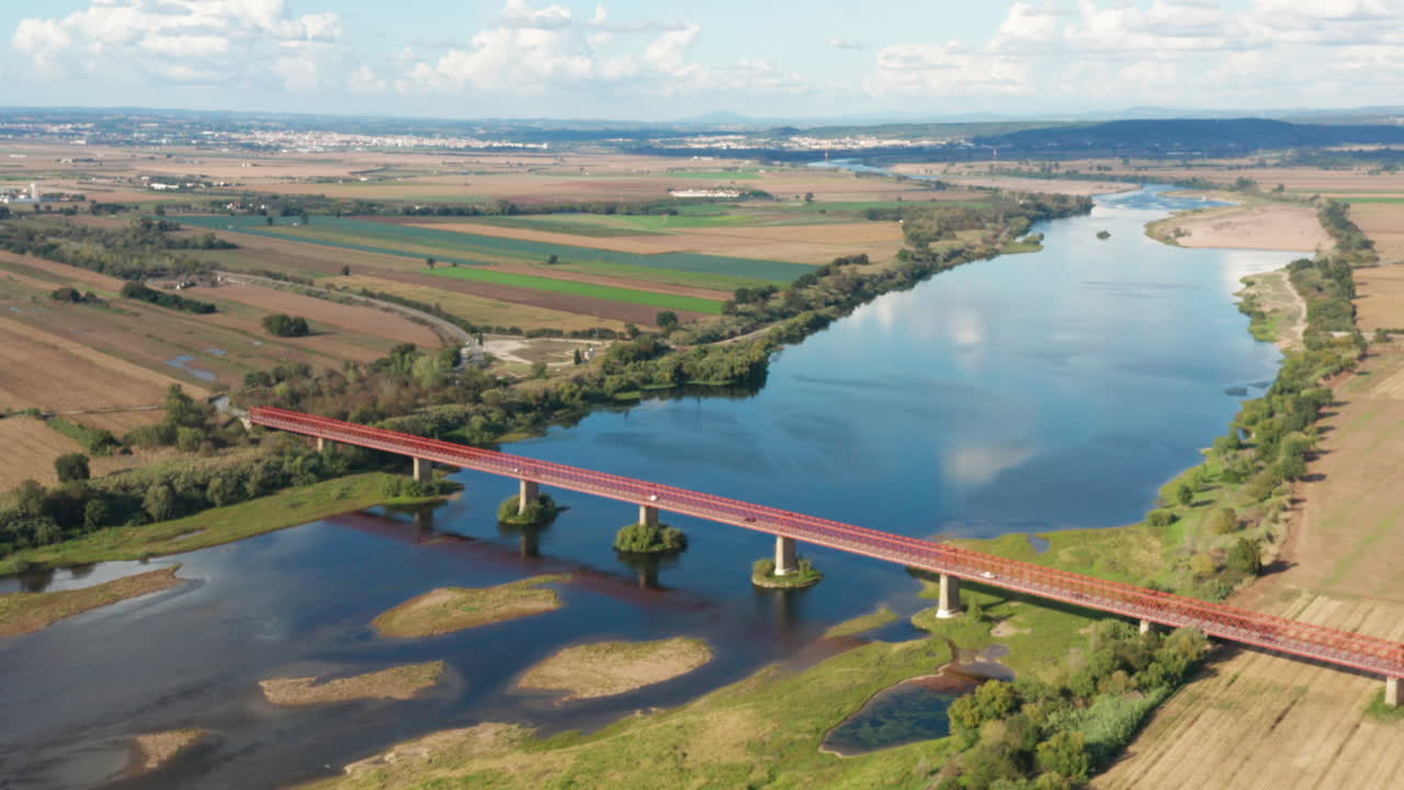 Aerial shot flying backwards reveal epic scenery over Chamusca bridge at Tagus river
