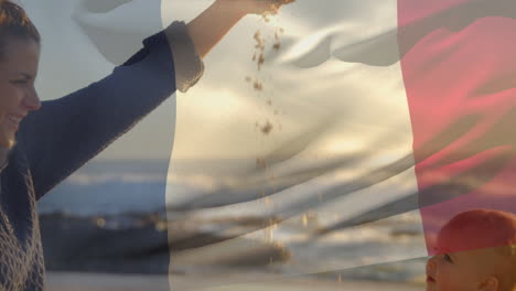 animación de la bandera de francia sobre una madre caucásica feliz con un niño jugando en la playa