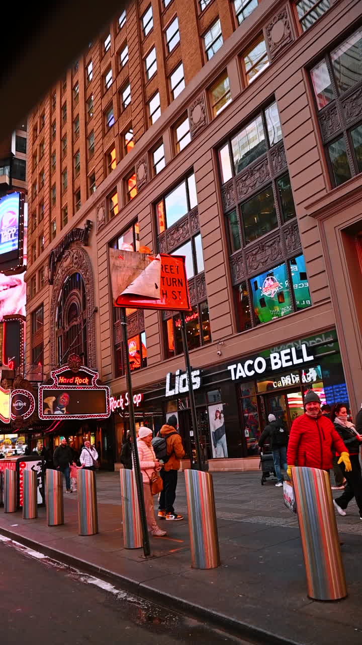 New York, USA, 8 October 2025: Times Square storefronts evening. Evening lights shine on shops and signs in busy Times Square New York