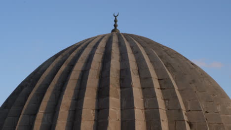 the camera zooms in on the metal pillar on one of the domes of the zinciriye madrasa and sees it closely