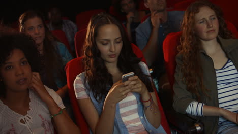 friends watching movie in cinema