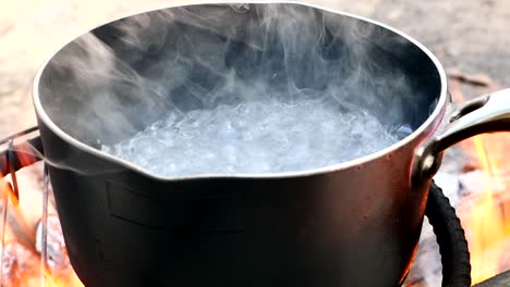 close up, water is boiling in a pot.