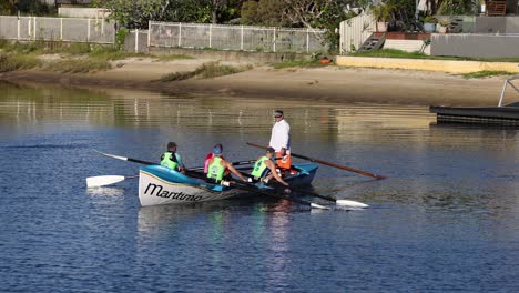 three people rowing a boat together