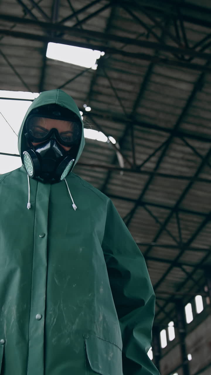 Man in gas mask on ruins. Man with gas mask and decontamination suit