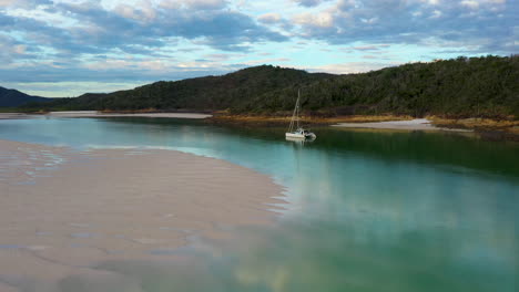 revealing drone shot from sailboat to wide shot of whitehaven beach whitsunday island australia