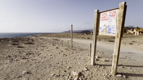 have fun don't judge anyone' sign on a desolate coastal roadside in fuerteventura, spain. concept of positivity, freedom, and non-judgment
