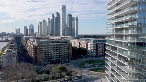 4k aerial drone footage of modern puerto madero with apartments and offices alone waterfront in buenos aires, argentina.