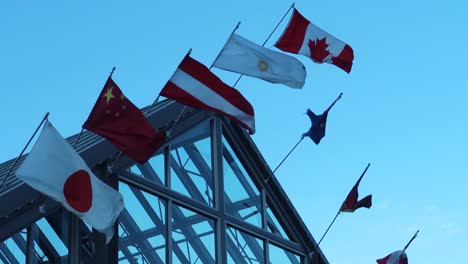 national flags on a roof, assembly or meeting of multiple nations