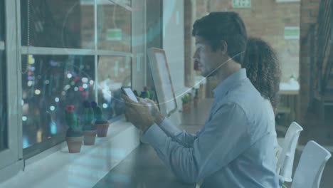 animation of graphs, loading circle on diverse man using cellphone and talking with female coworker