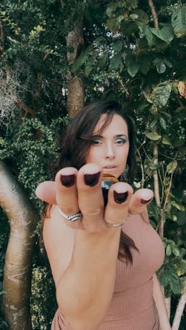 woman holding a tiger's eye gemstone outdoors