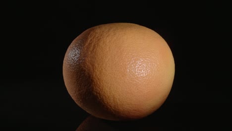 grapefruit close-up on a black background.