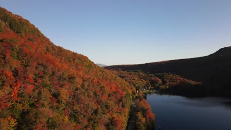 beautiful aerial drone footage of the fall leaves on and around mount hor, mount pisgah, and lake willoughby during peak autumn foliage at willoughby state forest in westmore, vermont