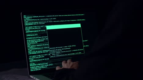 hands hacker using laptop computer hacking in the dark room