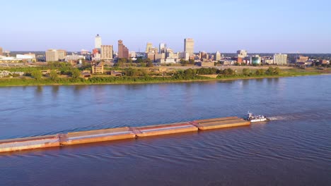 good aerial over a barge on the mississippi river with downtown business district of memphis tennessee in background 2