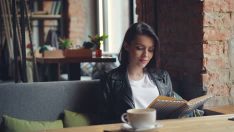 woman reading a book in a cozy cafe