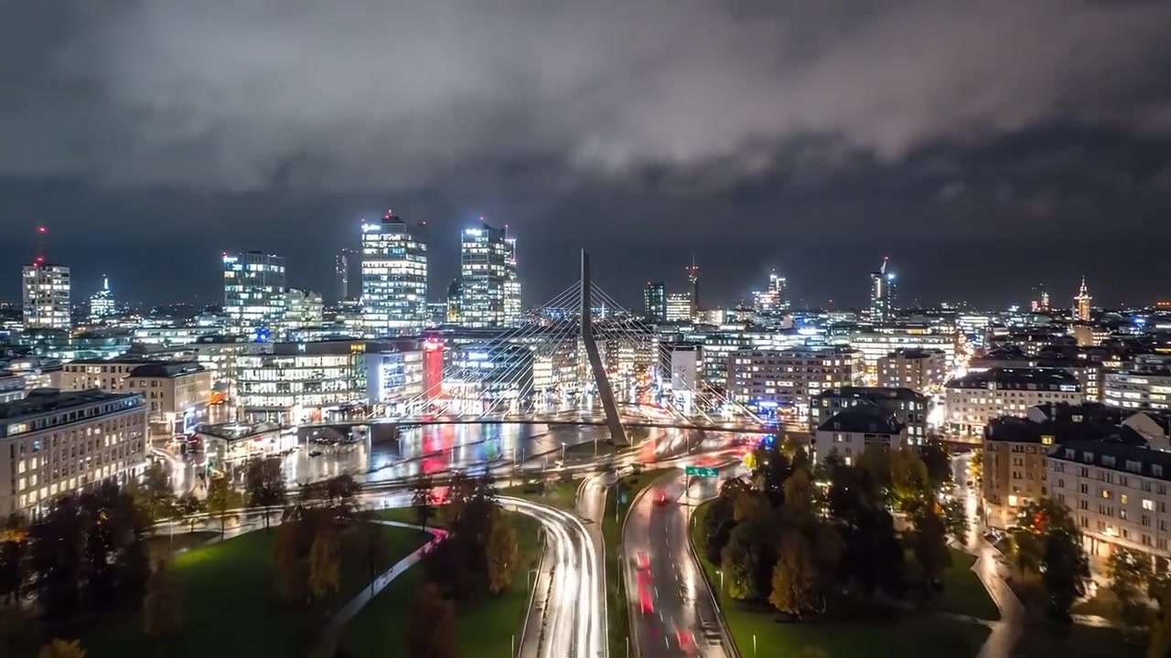 A Night Scene of Urban Life: Illuminated Streets, Reflections, and Rain Showcasing City Dynamics in a Modern Metropolitan Environment