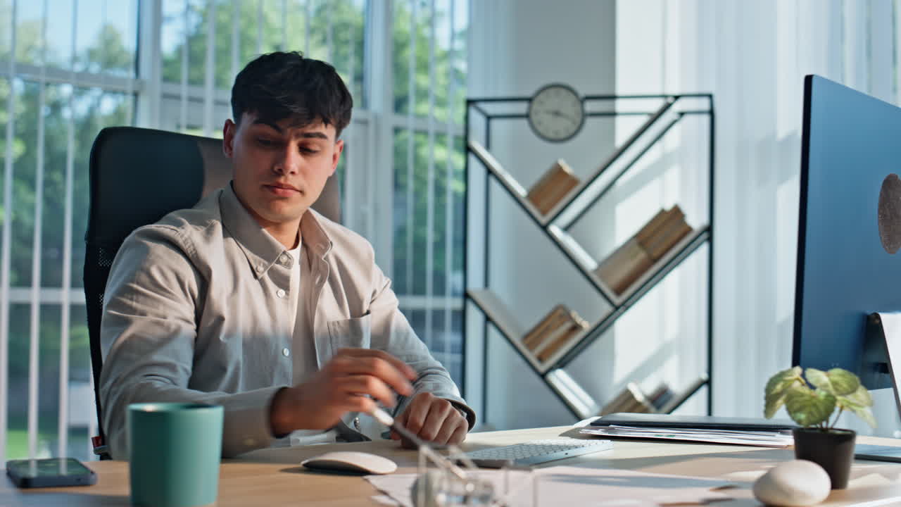 Overworked guy looking computer monitor buro closeup. Businessman touching head