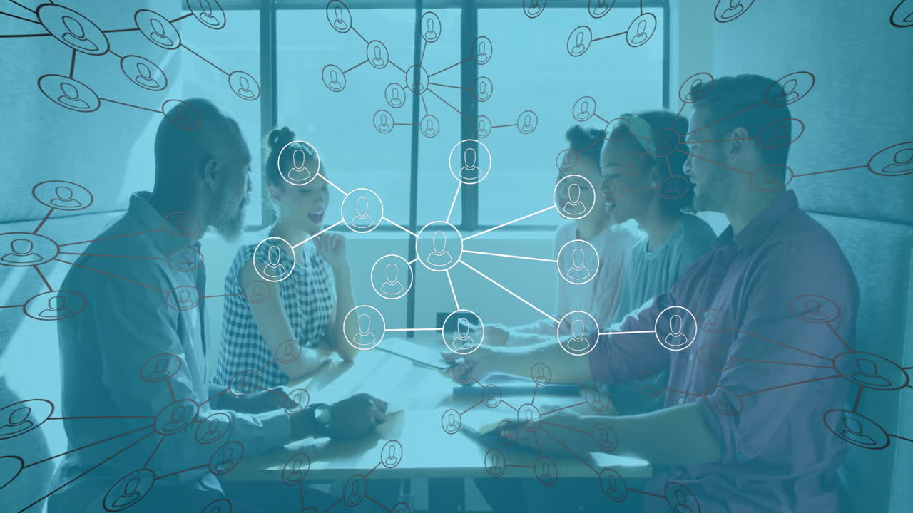 Diverse team collaborating at table with network connections animation overlay