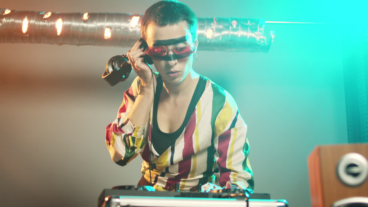 Happy artist working as dj with electric turntables