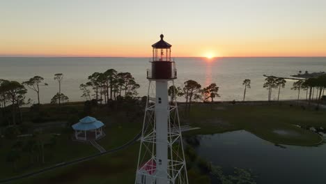 drone video of a sunset passing through the cape san blas lighthouse in port st