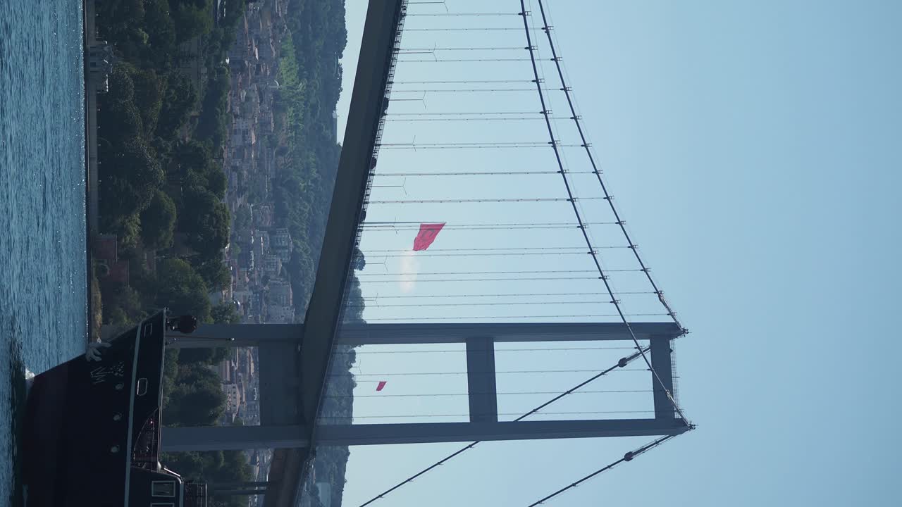 Bosphorus Bridge with Turkish Flag and Ship on a Sunny Day