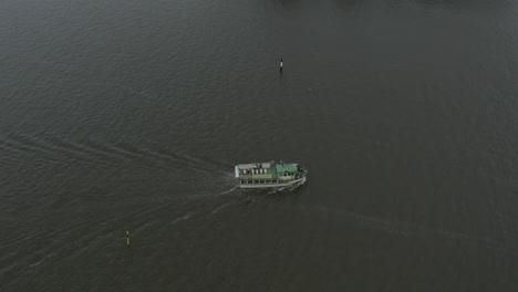 drone shot of small cruise boat sails at the sea