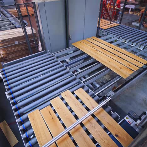 wood planks on an industrial conveyor belt in a factory