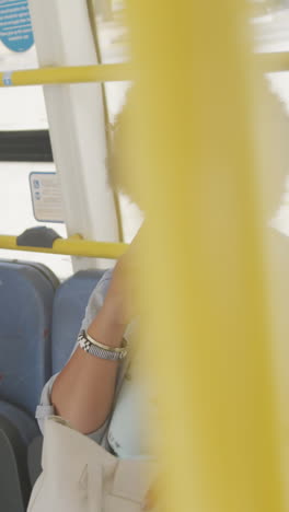 happy plus size biracial woman talking on smartphone in bus