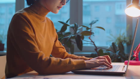 Businesswoman Typing on Laptop at Office Desk