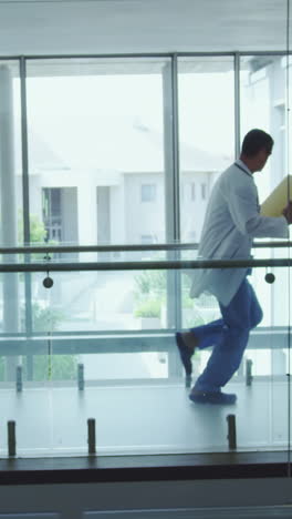 male and female doctors running in the corridor at hospital
