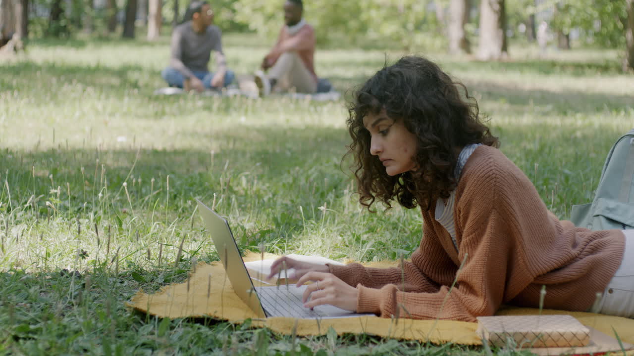공원에서 노트북으로 일하는 여자