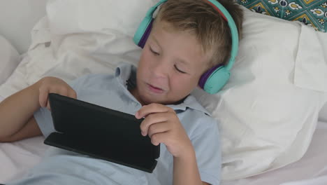 kid relaxing with tablet pc at home