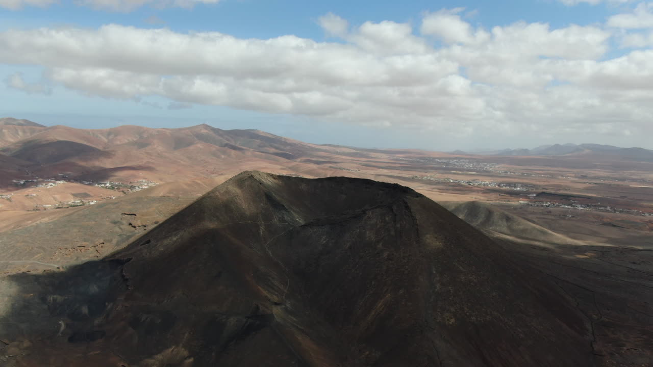 Gairia volcanic caldera: aerial view with lateral movement to the caldera on a sunny day and with beautiful orange colors
