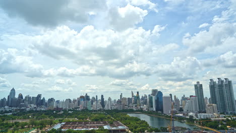 4k time lapse of fantastic fast clouds moving over the modern bangkok cityscape near benjakitti park and lake daytime