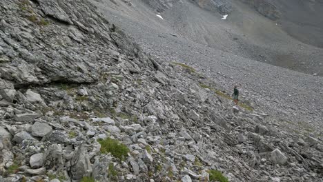 Hiker-looking-up-mountain-rocks-Rockies-Kananaskis-Alberta-Canada