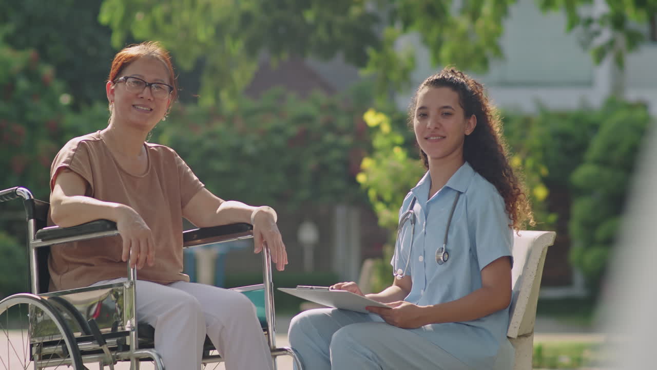 Caregiver and elderly woman in wheelchair