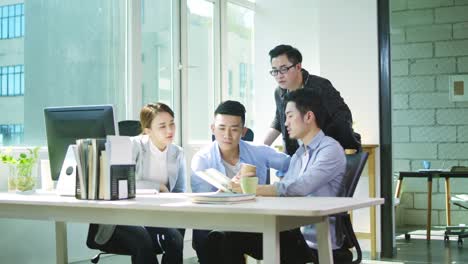 team of asian businesspeople discussing business in office