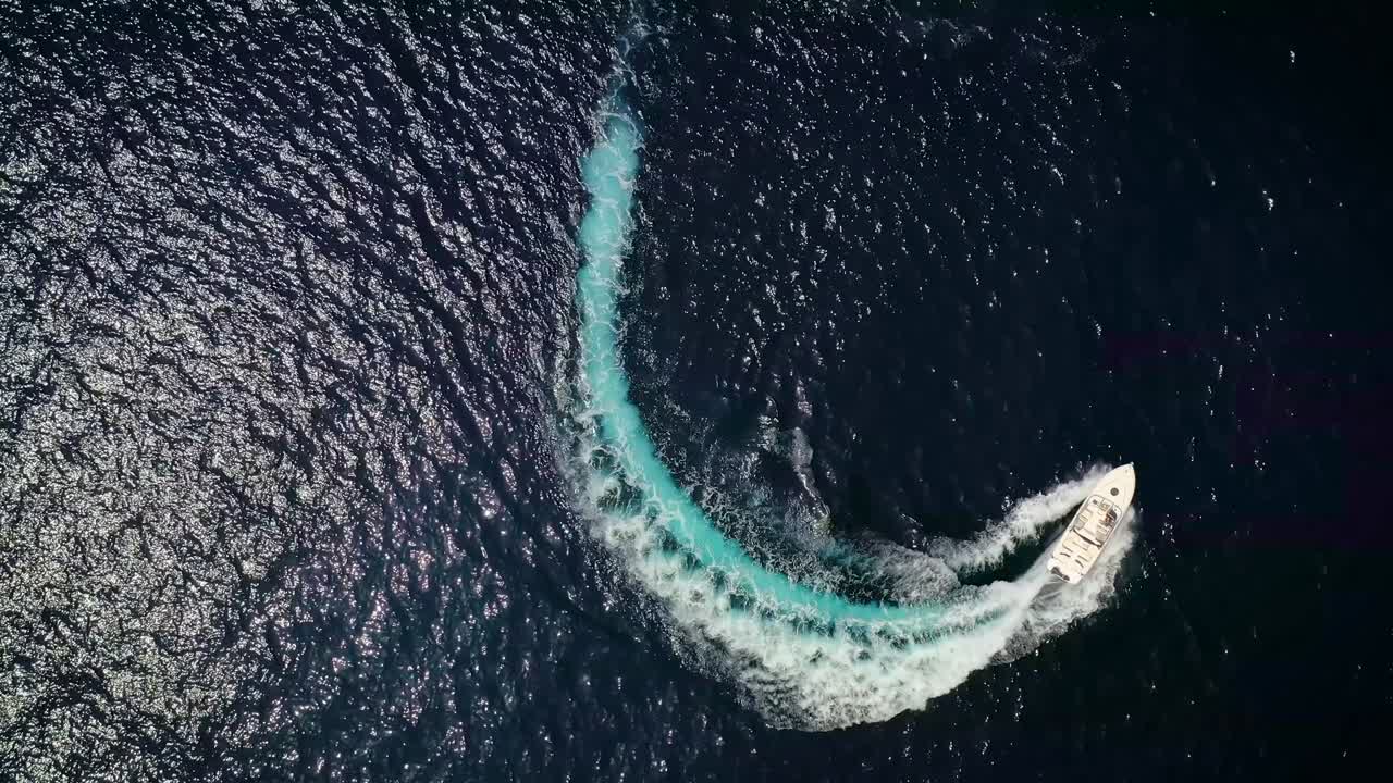 고급 모터 보트는 파도와 거품의 원을 형성합니다.