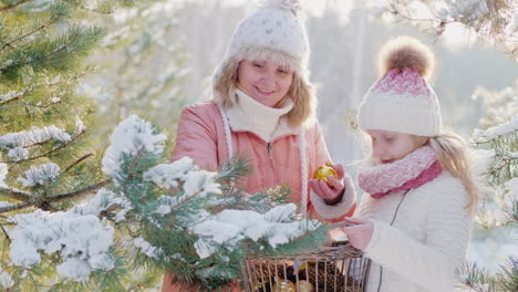 Ein-Kleines-Mädchen-Und-Eine-Junge-Mutter-Schmücken-Einen-Weihnachtsbaum-Mit-Dekorativen-Kugeln-Im-Schnee